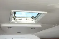 Ceiling view of 2008 Rinker 260 boat with skylight and recessed lighting.