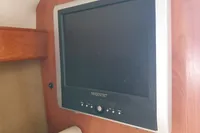 Majestic TV inside 2008 Rinker 260 boat cabin, mounted on wooden panel.