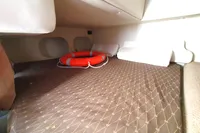 2008 Rinker 260 boat cabin interior with life preserver on patterned bed.