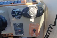 Control panel of a 2008 Rinker 260 boat with various switches and gauges.
