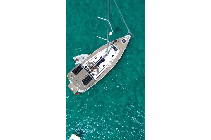 Lazy Days Yacht Photos Pics Aerial view of 2015 Jeanneau Sun Odyssey 469 sailboat on turquoise water.