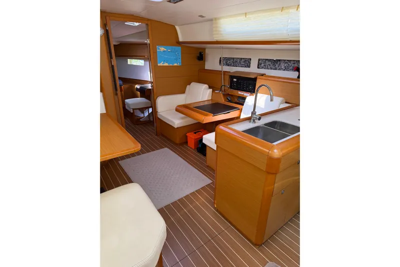 Lazy Days Yacht Photos Pics Interior of 2015 Jeanneau Sun Odyssey 469 yacht, featuring modern kitchen and seating area.