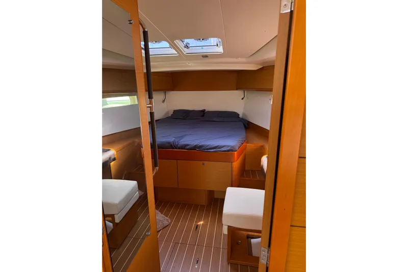Lazy Days Yacht Photos Pics Cozy cabin interior of 2015 Jeanneau Sun Odyssey 469 sailboat with wooden finishes.