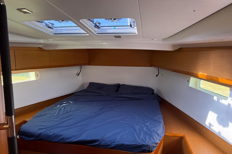 Lazy Days Yacht Photos Pics Cozy cabin interior of 2015 Jeanneau Sun Odyssey 469 sailboat with skylights and wooden accents.