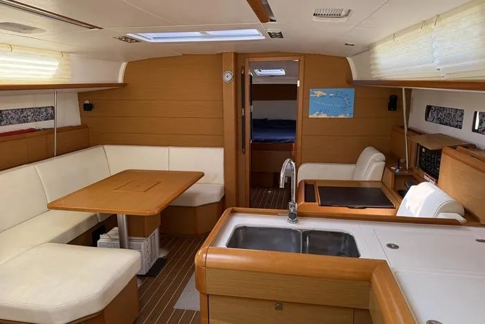 Lazy Days Yacht Photos Pics Interior of 2015 Jeanneau Sun Odyssey 469 yacht with modern kitchen and seating area.