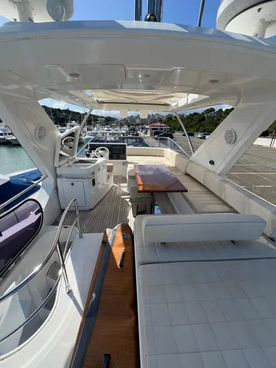 Lula Yacht Photos Pics 2016 Azimut 54fly yacht interior with seating and helm, docked at marina.