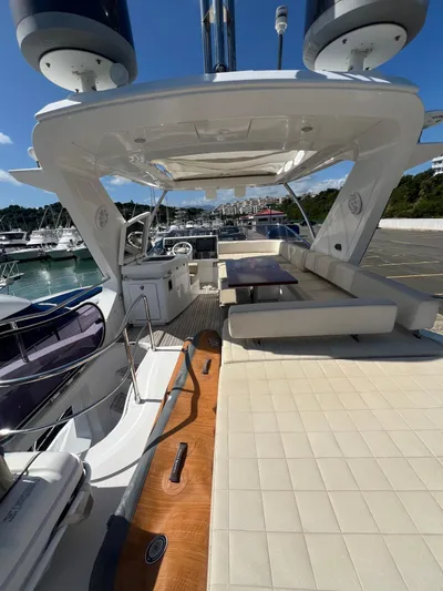 Lula Yacht Photos Pics Azimut 54fly 2016 yacht with spacious deck, seating, and table, docked at marina.