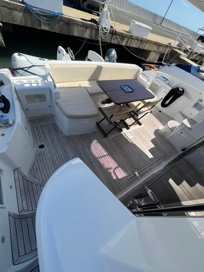 Lula Yacht Photos Pics 2016 Azimut 54fly yacht deck with seating and table, docked at marina.