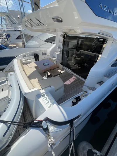 Lula Yacht Photos Pics Azimut 54fly 2016 yacht with spacious deck and seating area in marina.