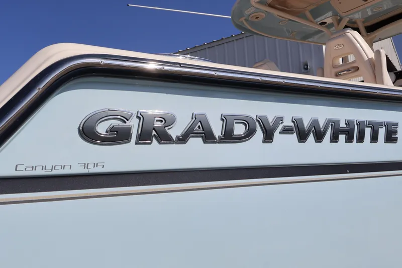  Yacht Photos Pics 2017 Grady-White Canyon 306 boat side view with logo and model name.
