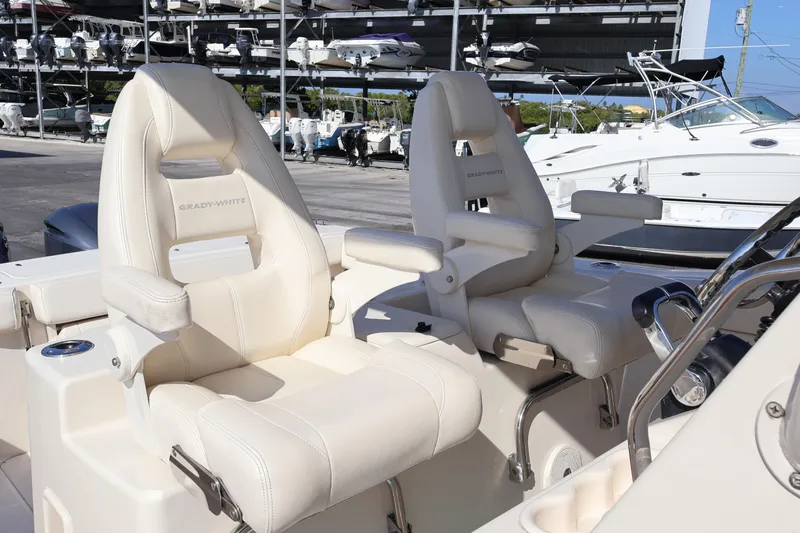  Yacht Photos Pics 2017 Grady-White Canyon 306 boat seats, luxurious white leather, docked marina background.