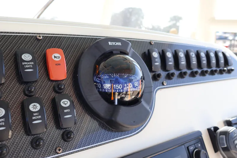  Yacht Photos Pics Control panel of 2017 Grady-White Canyon 306 boat with compass and switches.