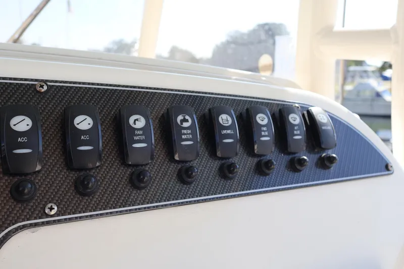  Yacht Photos Pics Control panel of a 2017 Grady-White Canyon 306 boat with labeled switches.