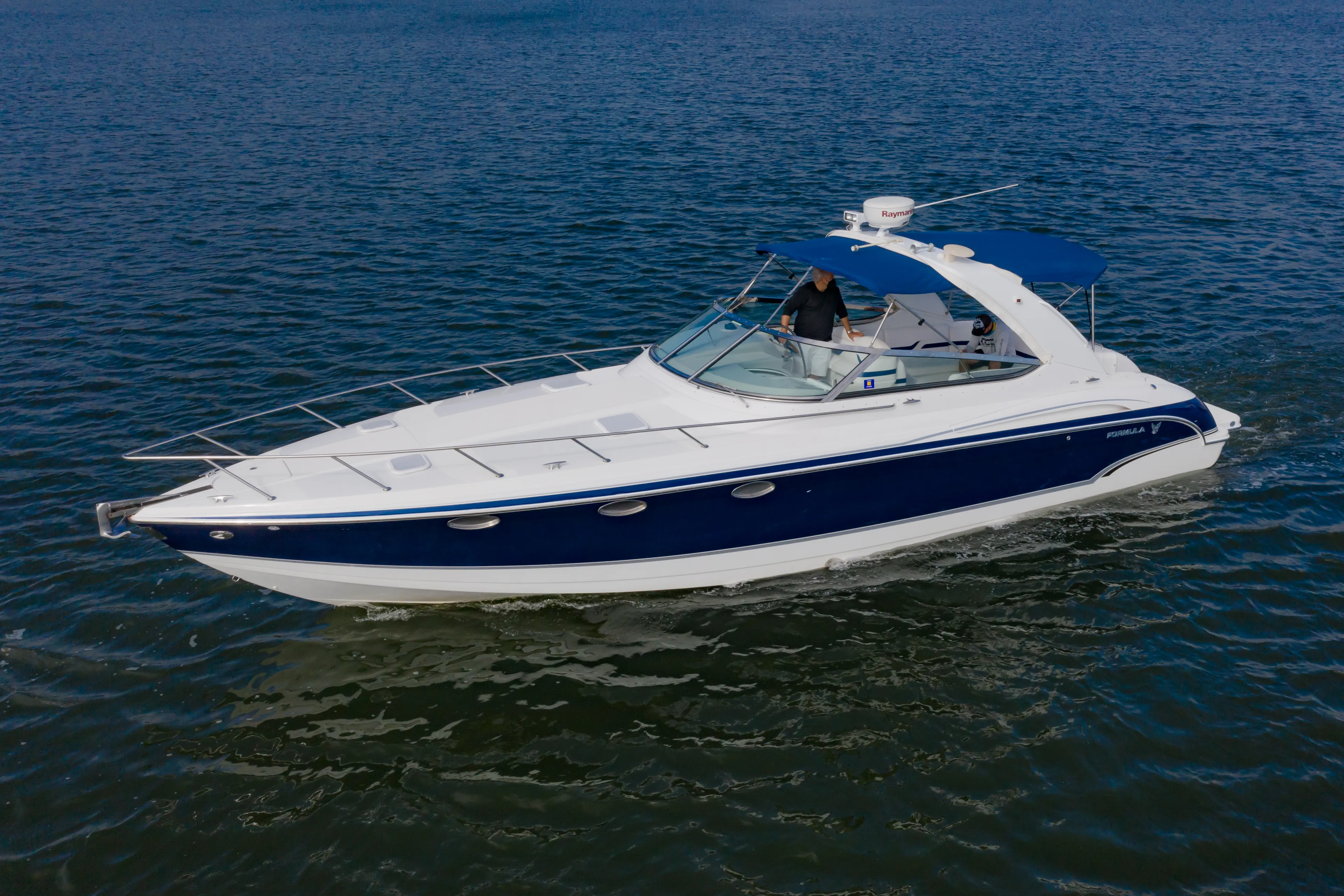 Carmita's Way Yacht Photos Pics 2007 Formula 370 Super Sport boat cruising on open water.