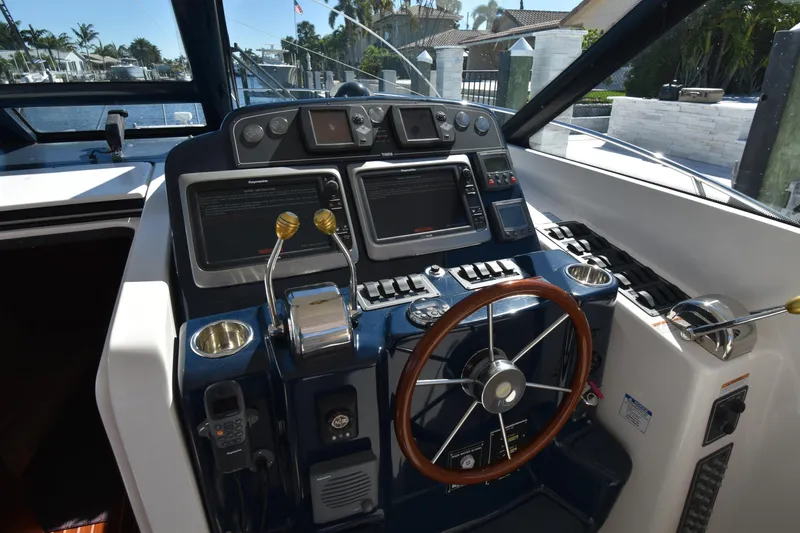 Bossa Nova Yacht Photos Pics 2006 Tiara Yachts 3600 Open helm with navigation controls and steering wheel.