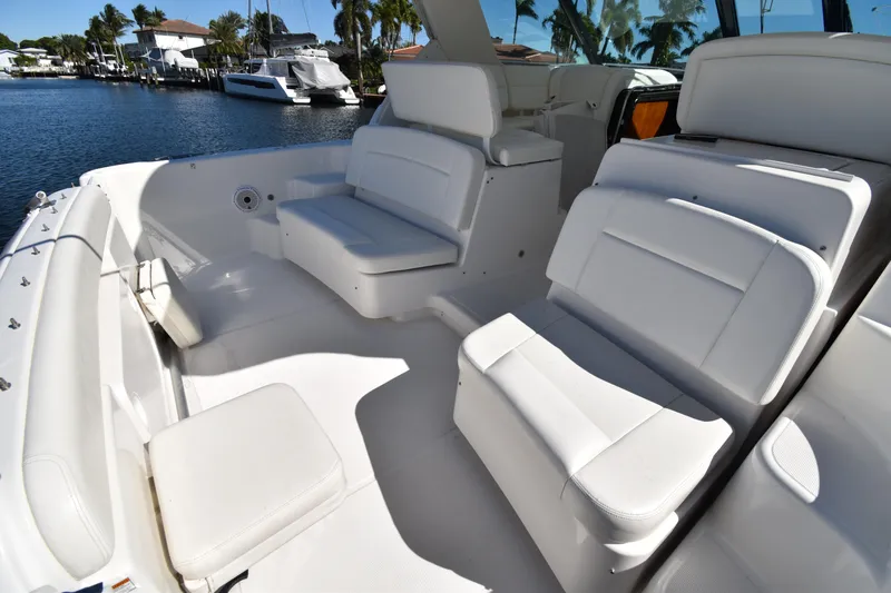 Bossa Nova Yacht Photos Pics 2006 Tiara Yachts 3600 Open with white seating, docked by waterfront homes.