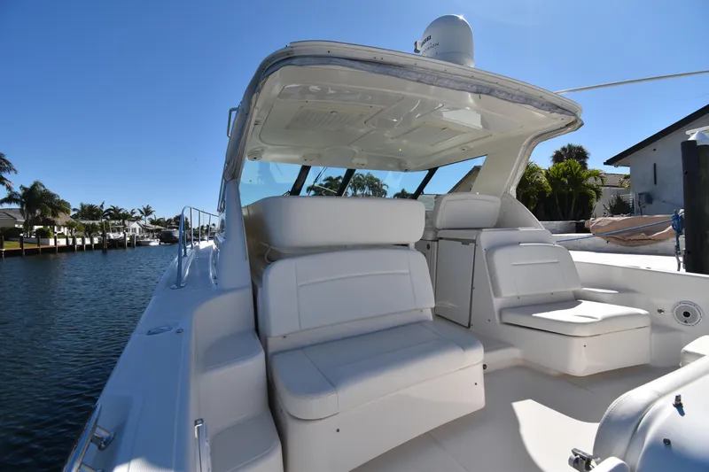 Bossa Nova Yacht Photos Pics 2006 Tiara Yachts 3600 Open with spacious seating, docked by a serene waterfront.