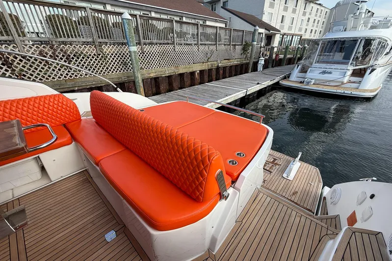  Yacht Photos Pics Azimut Atlantis 43 yacht, 2016 model, featuring vibrant orange seating and docked at a marina.