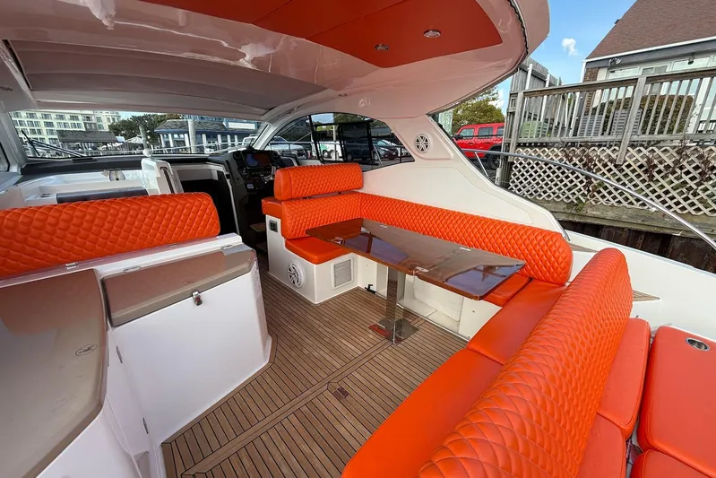  Yacht Photos Pics 2016 Azimut Atlantis 43 yacht interior with vibrant orange seating and sleek wooden flooring.