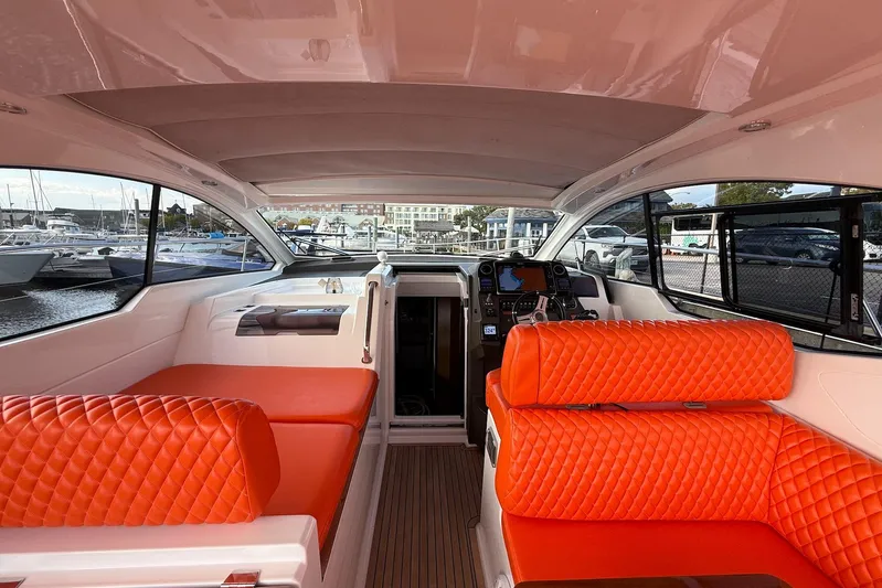  Yacht Photos Pics Interior of 2016 Azimut Atlantis 43 yacht with vibrant orange seating and modern dashboard.