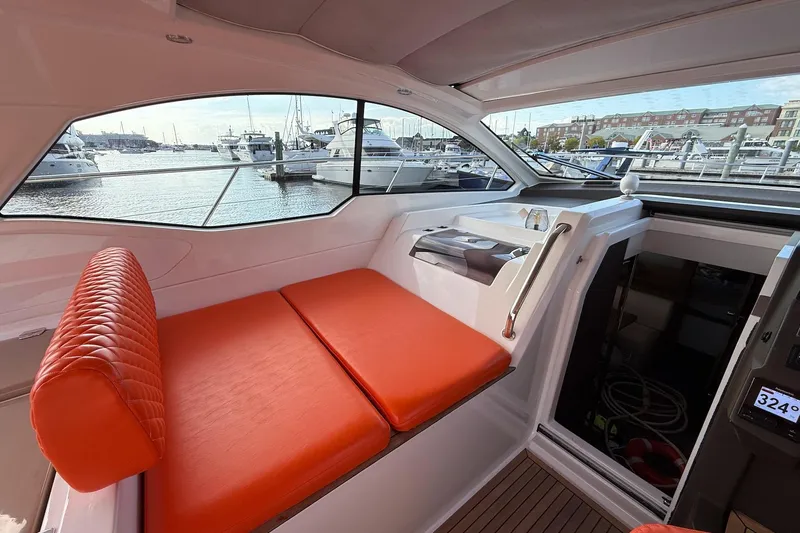  Yacht Photos Pics Interior of 2016 Azimut Atlantis 43 yacht with orange seating, overlooking marina.