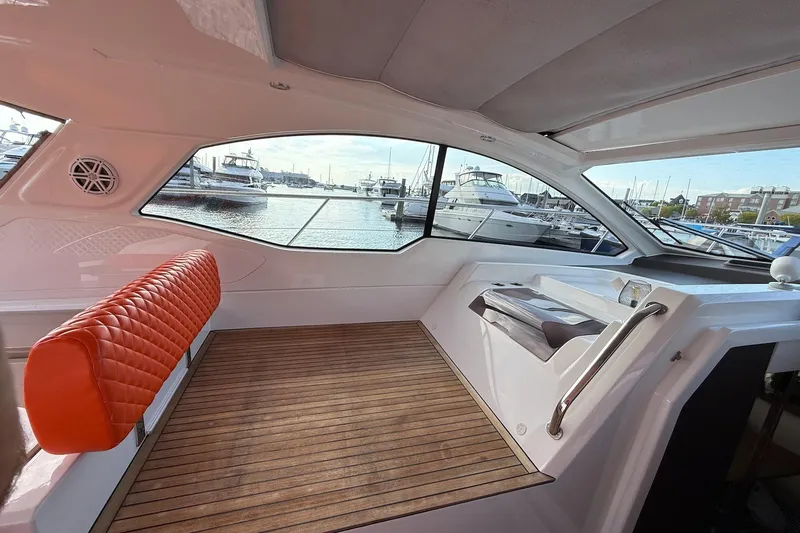  Yacht Photos Pics Interior of 2016 Azimut Atlantis 43 yacht with orange seating and marina view.