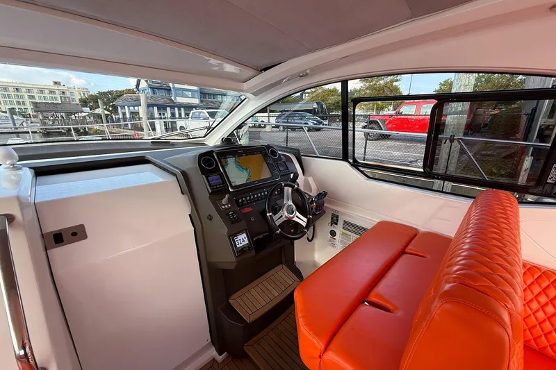  Yacht Photos Pics Interior of 2016 Azimut Atlantis 43 yacht with orange seating and modern navigation system.