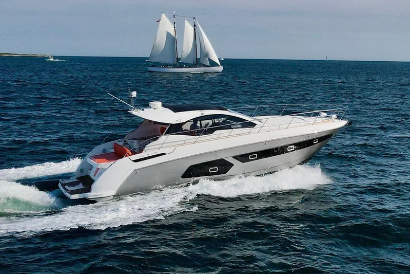  Yacht Photos Pics Azimut Atlantis 43 yacht cruising on open sea, 2016 model, with sailboat in background.