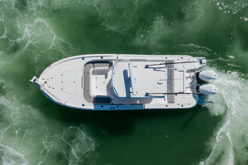  Yacht Photos Pics Aerial view of 2022 Caymas 28 HB boat navigating green waters.