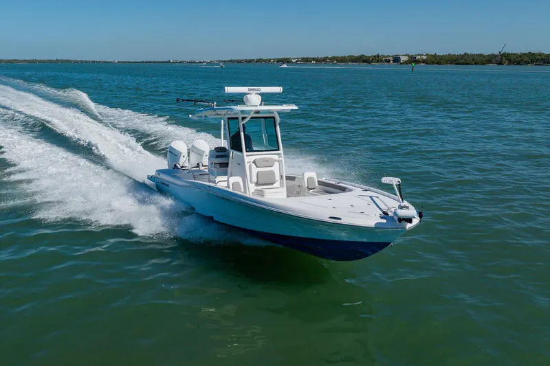  Yacht Photos Pics 2022 Caymas 28 HB boat cruising on open water, showcasing sleek design and performance.