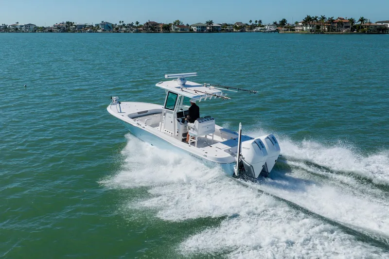  Yacht Photos Pics 2022 Caymas 28 HB boat cruising on open water, showcasing powerful twin engines.