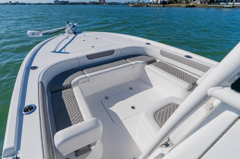  Yacht Photos Pics 2022 Caymas 28 HB boat interior with cushioned seating on calm water.