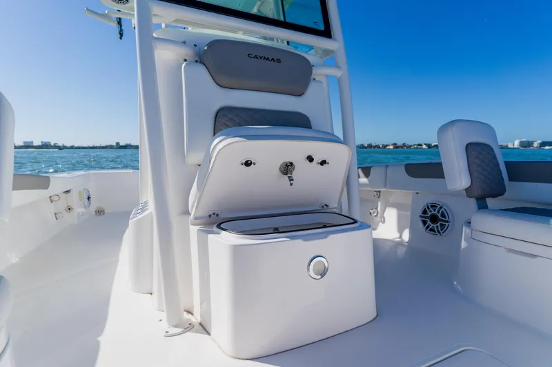  Yacht Photos Pics 2022 Caymas 28 HB boat interior with open storage compartment, ocean view.