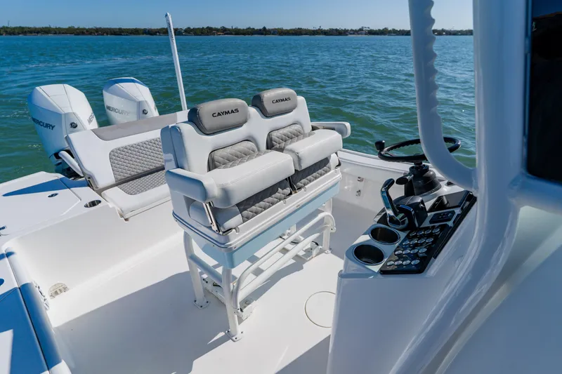  Yacht Photos Pics 2022 Caymas 28 HB boat interior with dual Mercury engines on a sunny day.