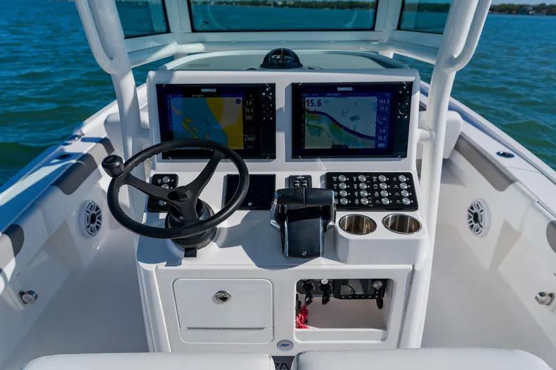  Yacht Photos Pics 2022 Caymas 28 HB boat dashboard with dual Simrad displays and steering wheel.