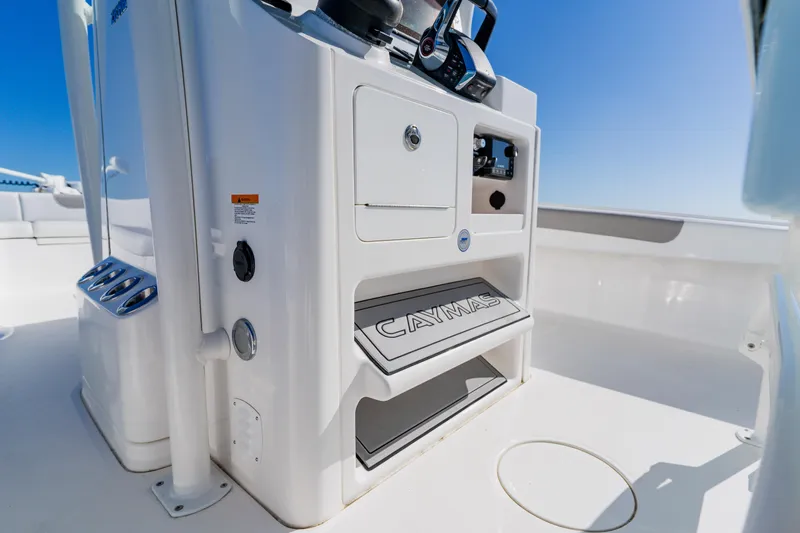  Yacht Photos Pics 2022 Caymas 28 HB boat console with storage compartments and controls under clear blue sky.