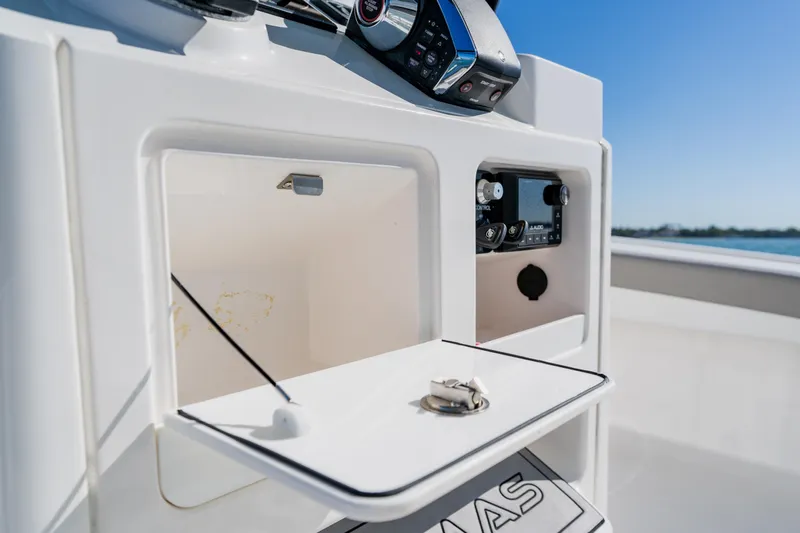 Yacht Photos Pics 2022 Caymas 28 HB boat console with storage compartments and control panel.