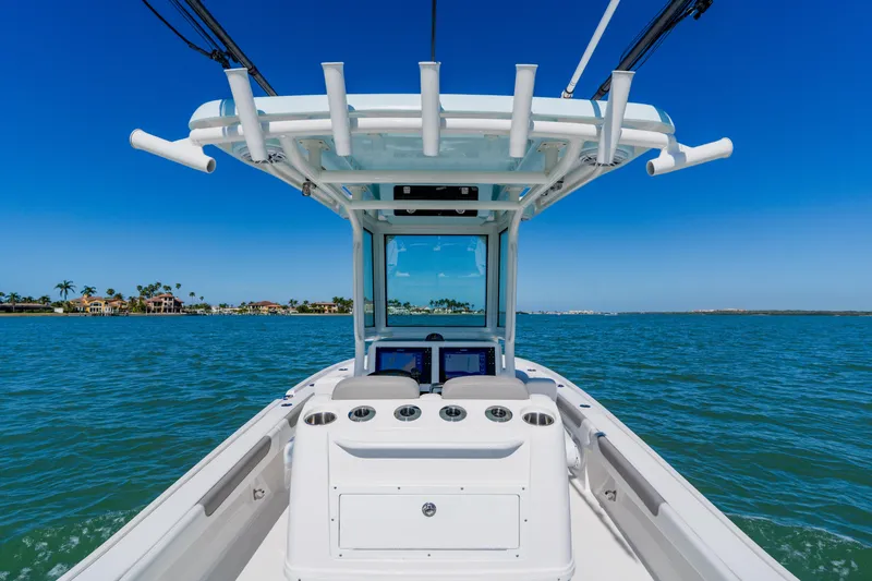  Yacht Photos Pics 2022 Caymas 28 HB boat cruising on clear blue water under a sunny sky.