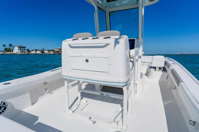  Yacht Photos Pics 2022 Caymas 28 HB boat interior with console, on calm blue water.