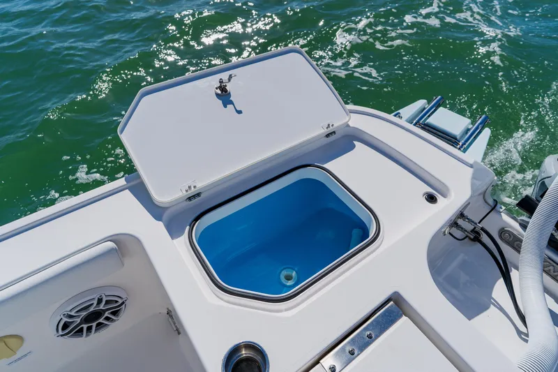  Yacht Photos Pics Open storage compartment on 2022 Caymas 28 HB boat, with ocean background.