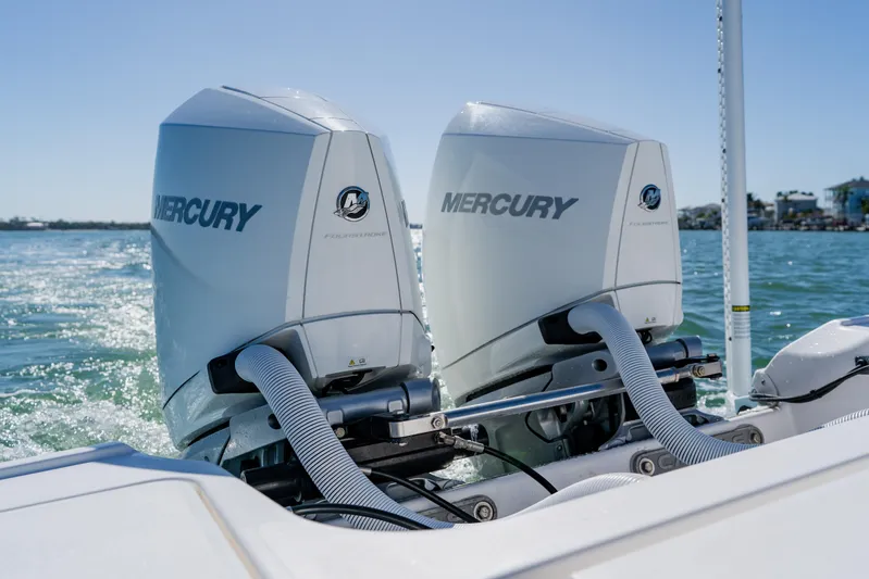 Yacht Photos Pics Twin Mercury outboard engines on a 2022 Caymas 28 HB boat in open water.