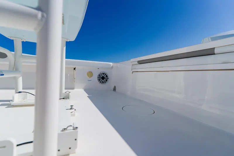  Yacht Photos Pics 2022 Caymas 28 HB boat deck with sleek white finish under clear blue sky.