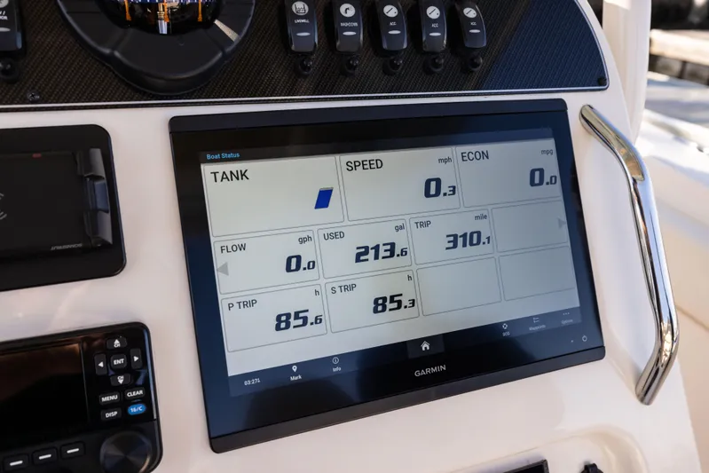 Shooter Yacht Photos Pics Garmin display on 2022 Grady-White 30.6 Canyon boat dashboard showing fuel and trip data.