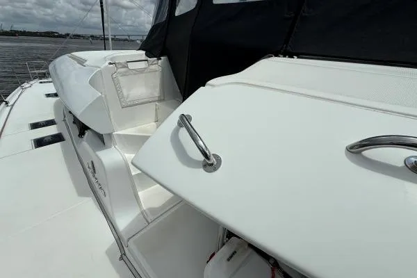 Tomcat Yacht Photos Pics 2023 Lagoon 46 yacht deck with sleek white design and stainless steel handles.