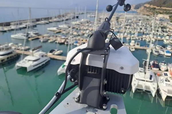 Tomcat Yacht Photos Pics Rooftop view of a 2023 Lagoon 46 yacht in a marina, surrounded by boats.