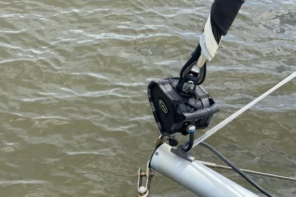 Tomcat Yacht Photos Pics Close-up of a 2023 Lagoon 46 sailboat rigging detail over water.