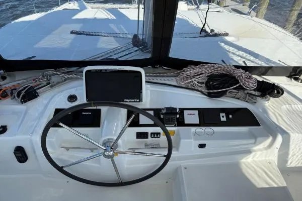 Tomcat Yacht Photos Pics 2023 Lagoon 46 yacht helm with navigation equipment and steering wheel.