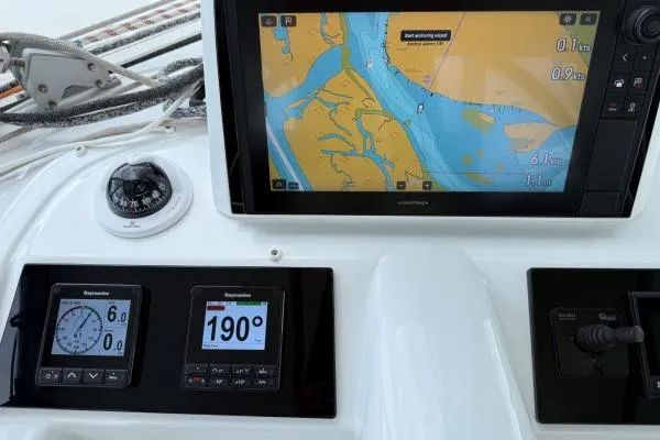 Tomcat Yacht Photos Pics Cockpit navigation instruments on 2023 Lagoon 46 catamaran, featuring GPS and compass displays.