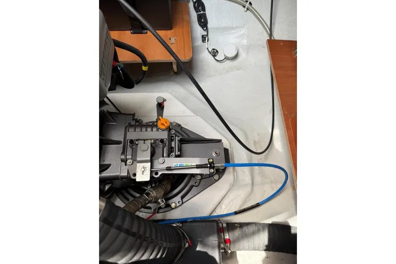 Tomcat Yacht Photos Pics Engine compartment of 2023 Lagoon 46 yacht, showcasing mechanical components and wiring.