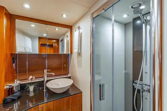 Catch The Wave Yacht Photos Pics Luxurious bathroom in 2013 Sunseeker Manhattan 73 yacht with modern fixtures and glass shower.